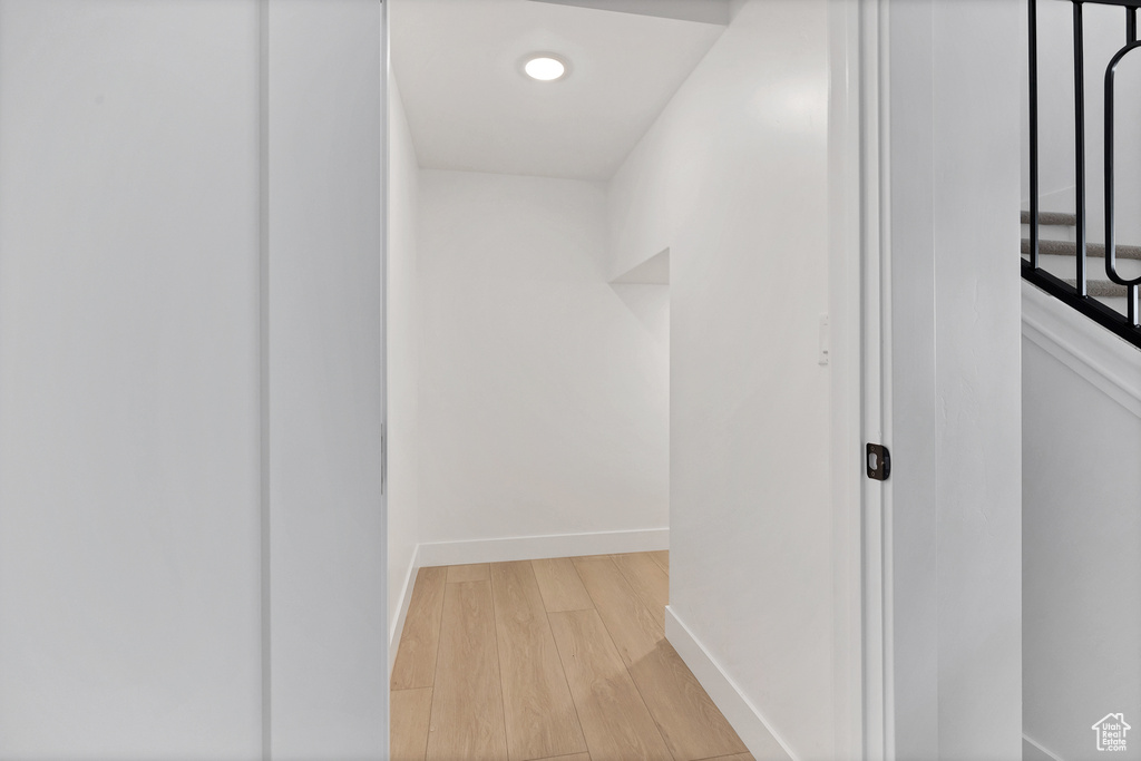 Corridor with light wood finished floors and recessed lighting