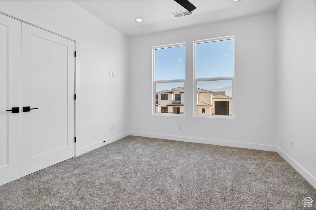 Carpeted empty room featuring recessed lighting and a ceiling fan