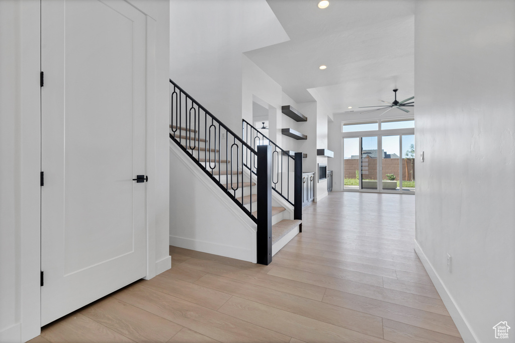 Foyer entrance featuring light wood-type flooring, stairs, a ceiling fan, and recessed lighting