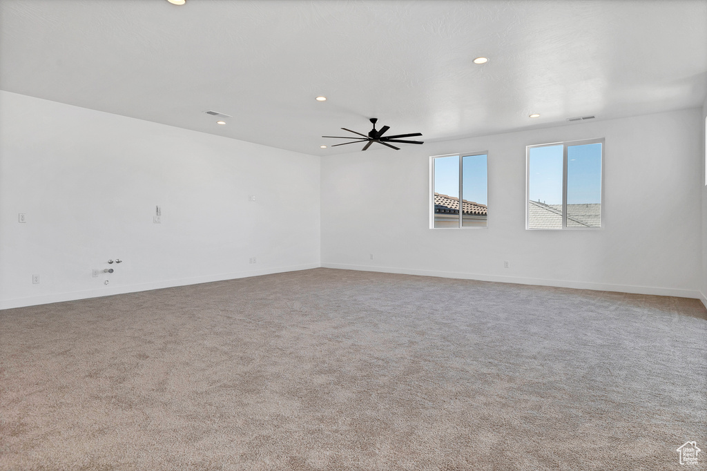 Carpeted spare room with recessed lighting and a ceiling fan