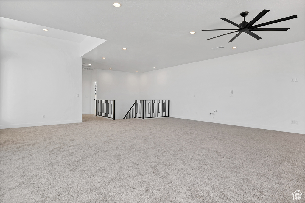 Spare room featuring recessed lighting, light colored carpet, and ceiling fan