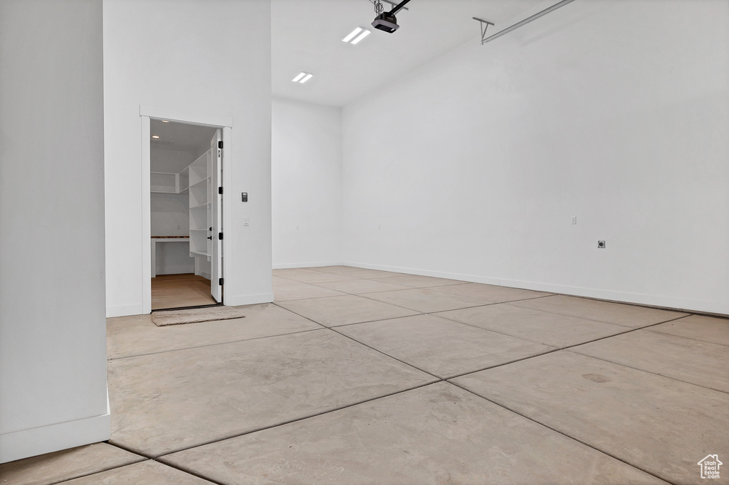 Garage with baseboards and a garage door opener