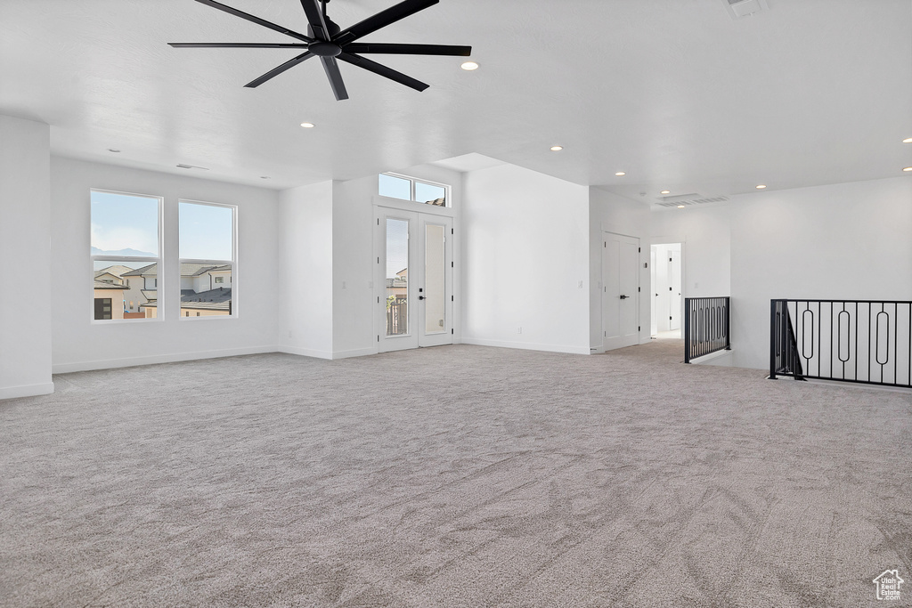 Unfurnished living room with carpet flooring, ceiling fan, and recessed lighting