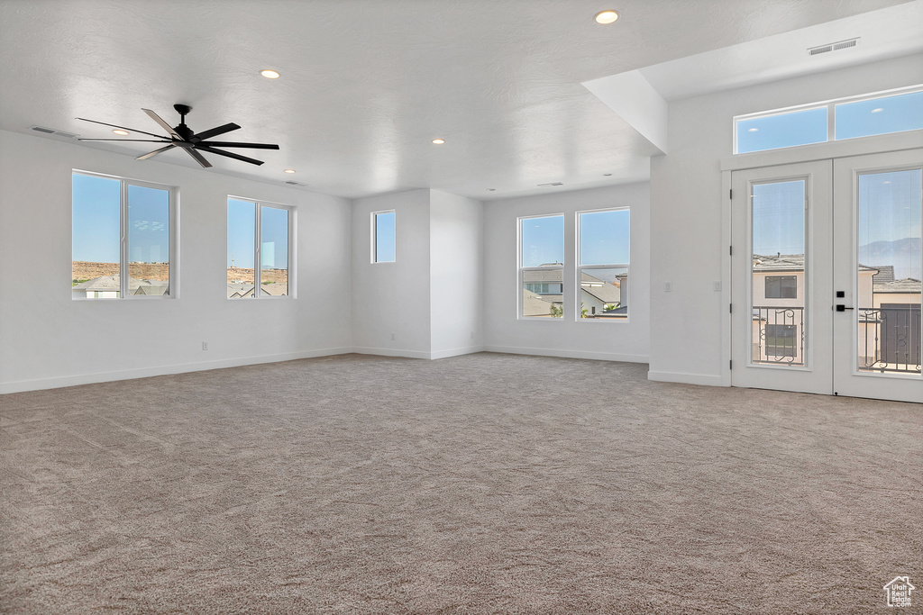 Unfurnished living room featuring carpet flooring, recessed lighting, french doors, and ceiling fan
