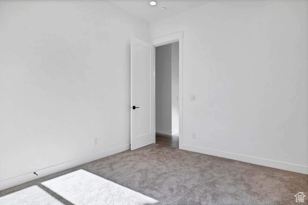 Unfurnished room with carpet flooring and baseboards