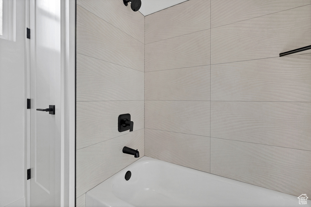 Bathroom featuring washtub / shower combination