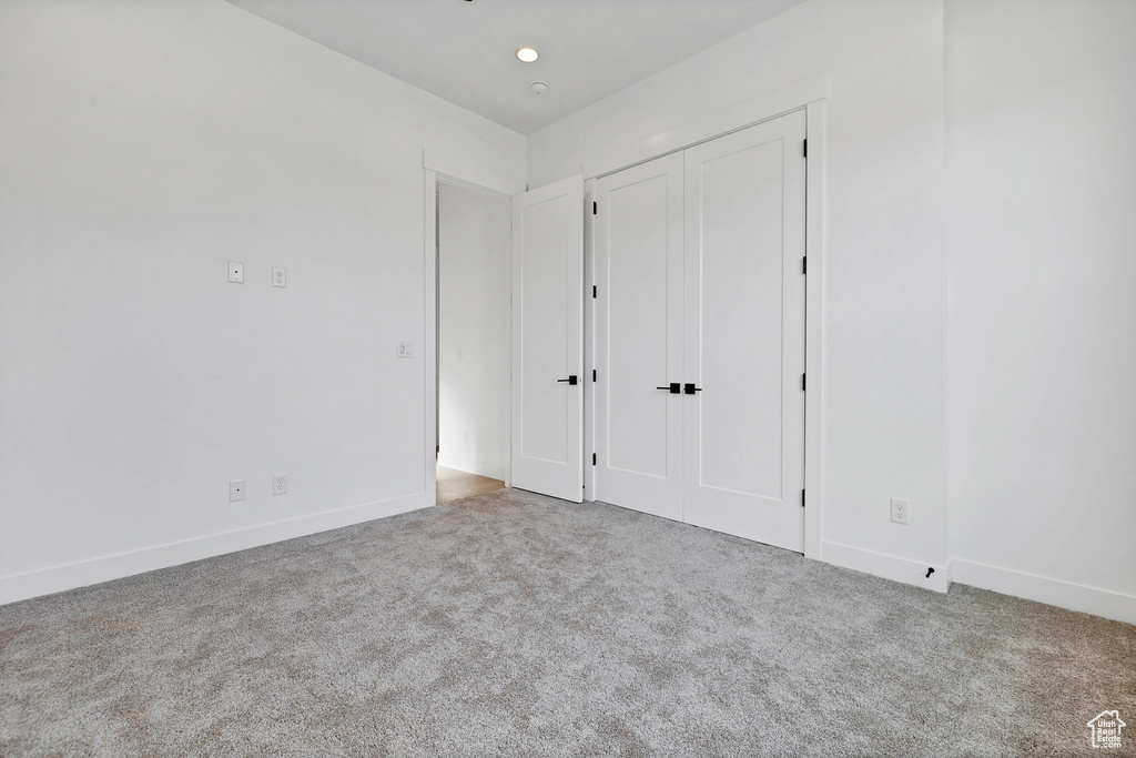 Unfurnished bedroom with carpet floors and a closet