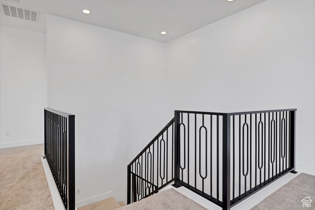 Staircase featuring recessed lighting and carpet