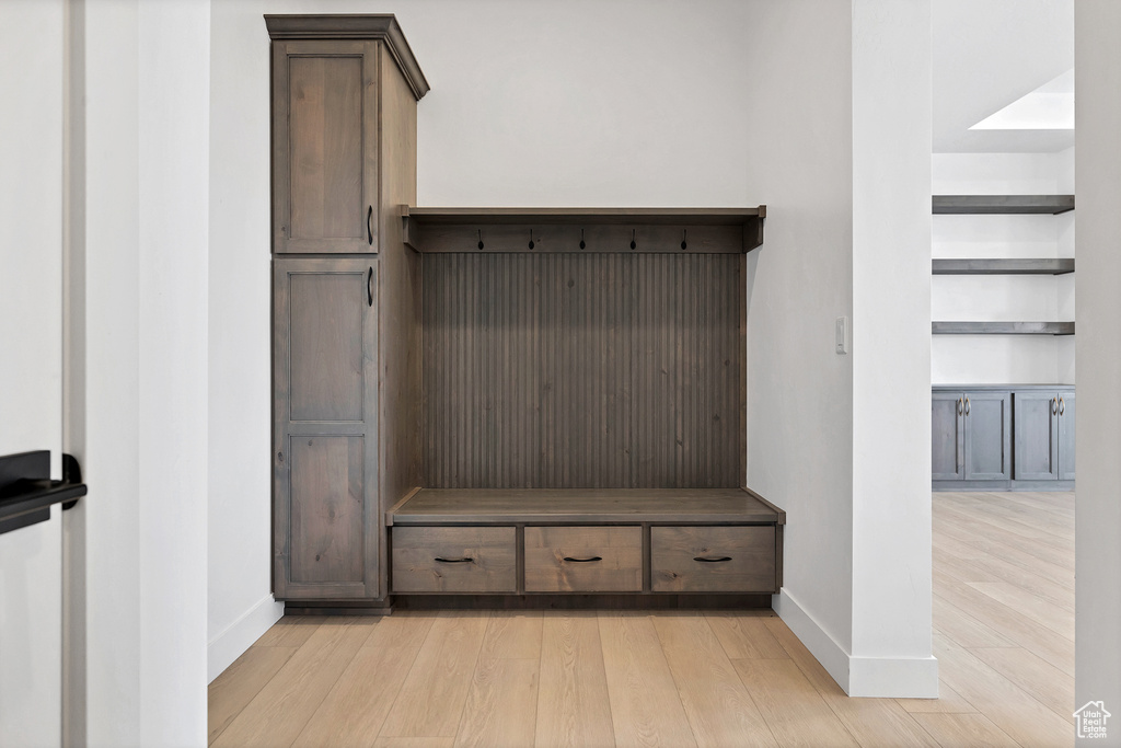 Mudroom featuring baseboards and light wood-type flooring
