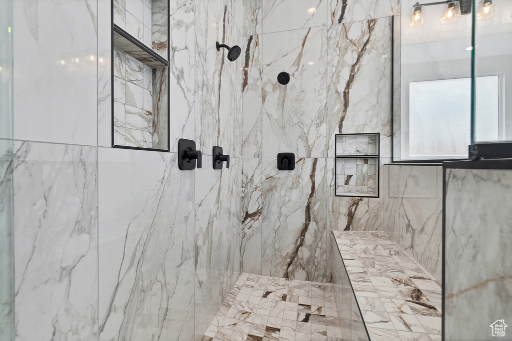 Bathroom featuring a marble finish shower
