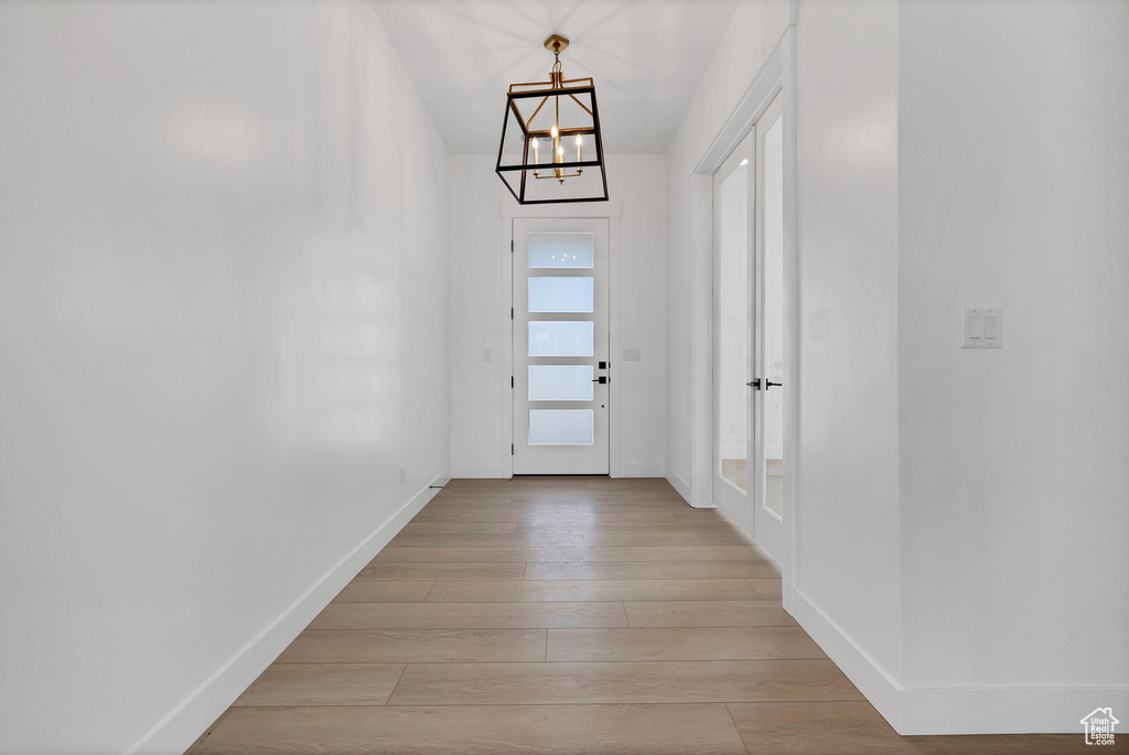 Entryway with a chandelier and light wood-style floors