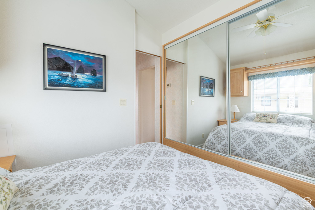 Bedroom featuring a closet, lofted ceiling, ceiling fan, and wood finished floors
