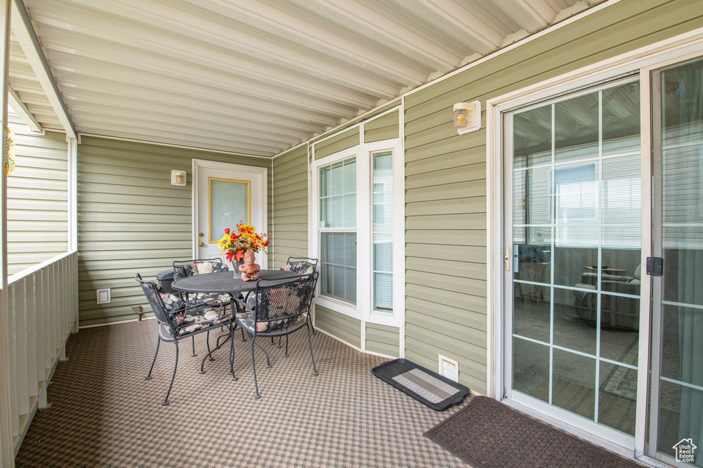 Sunroom / solarium with outdoor dining space