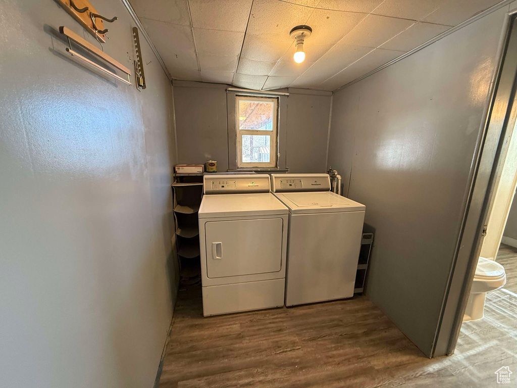 Washroom featuring separate washer and dryer and hardwood / wood-style floors