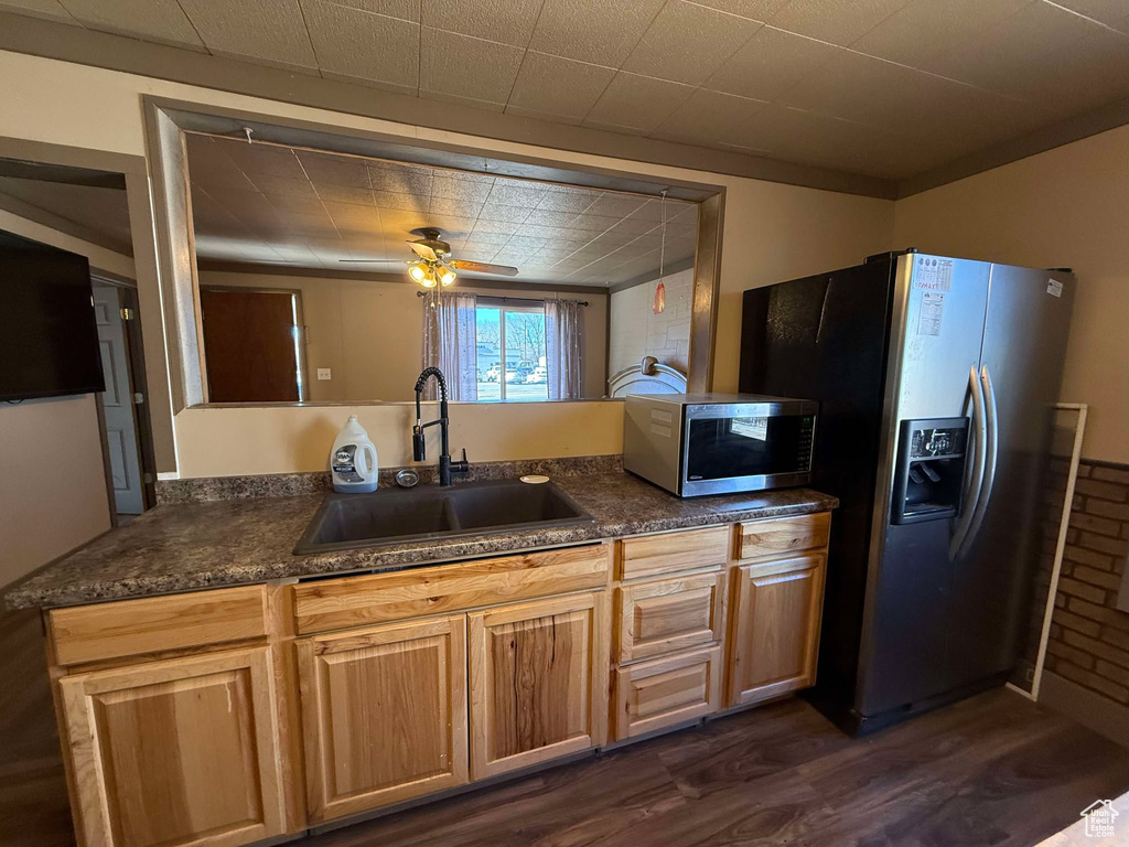 Kitchen featuring appliances with stainless steel finishes, sink, ceiling fan, kitchen peninsula, and dark wood-type flooring