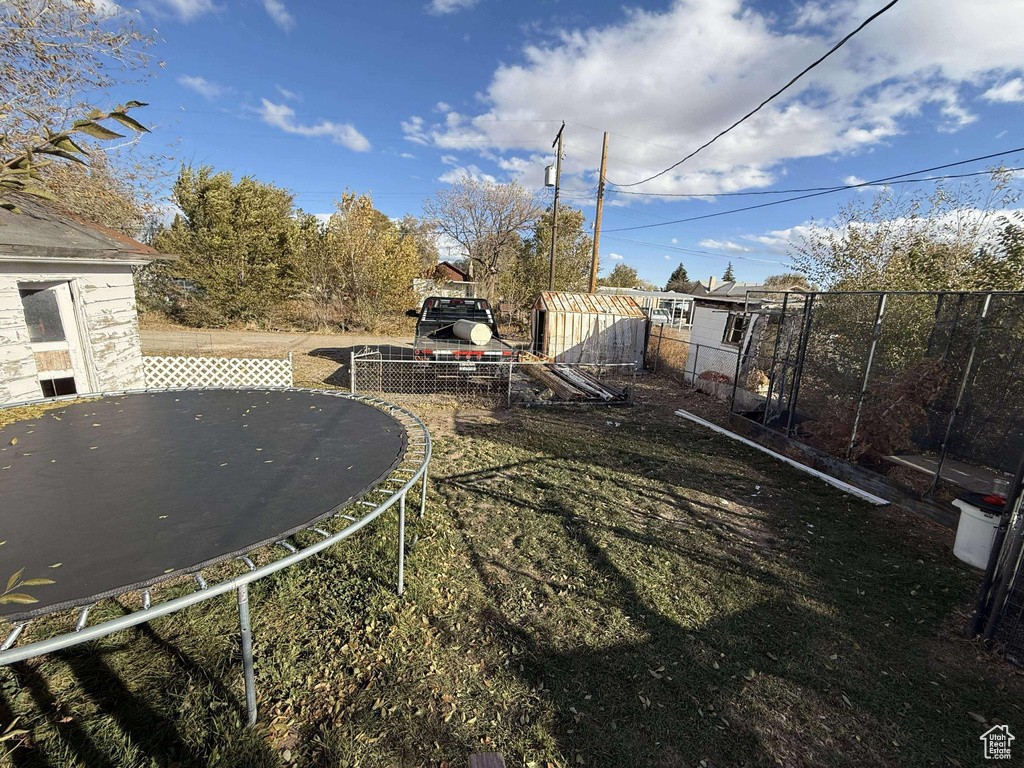 View of yard featuring a trampoline