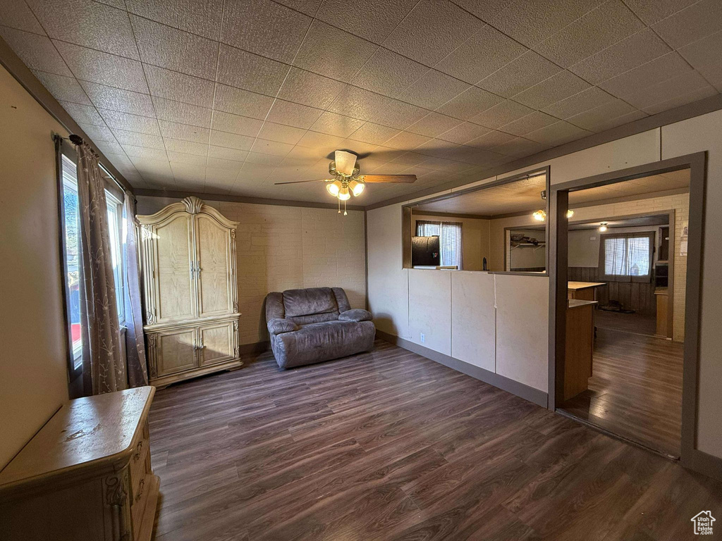 Unfurnished room featuring ceiling fan and dark hardwood / wood-style flooring