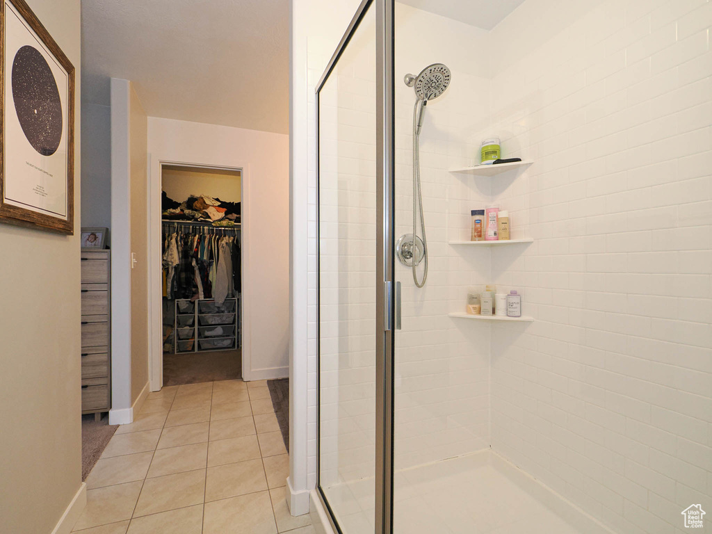 Bathroom featuring tile patterned floors and an enclosed shower