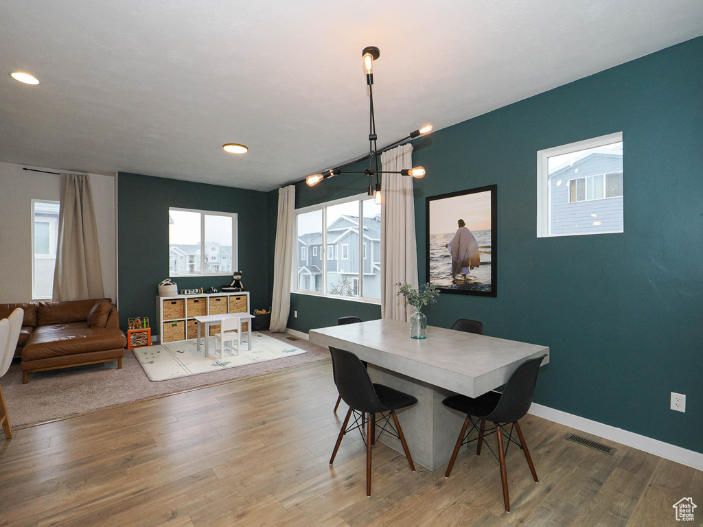 Dining room featuring a notable chandelier and light wood-type flooring