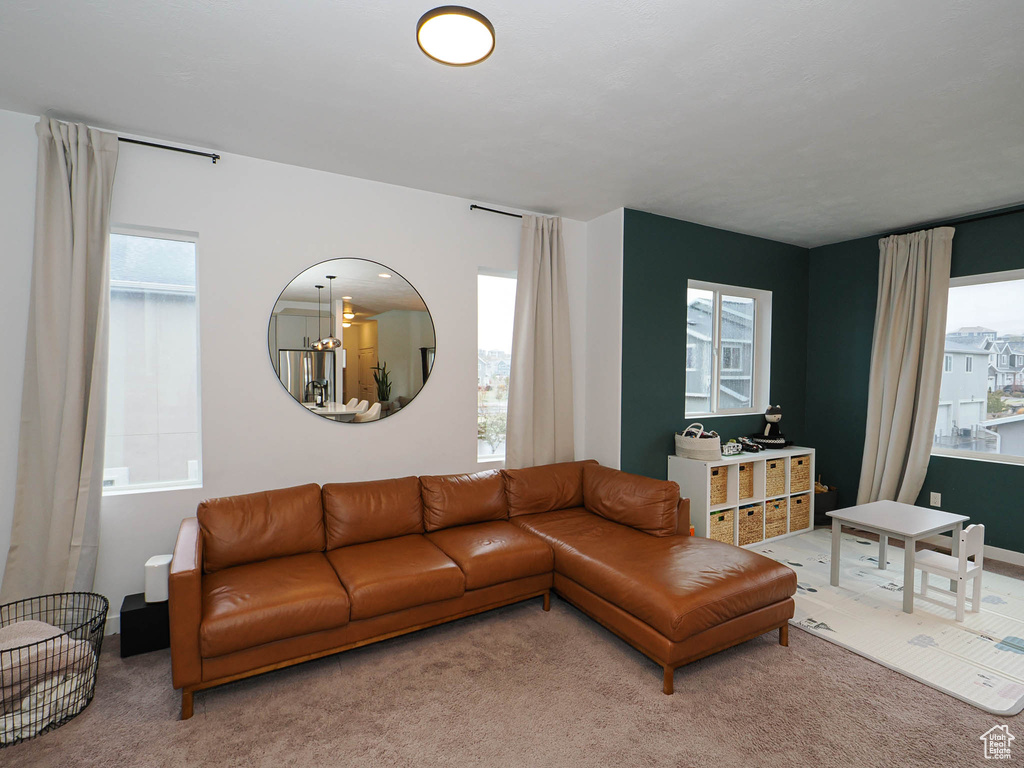 Living room featuring carpet flooring and an inviting chandelier