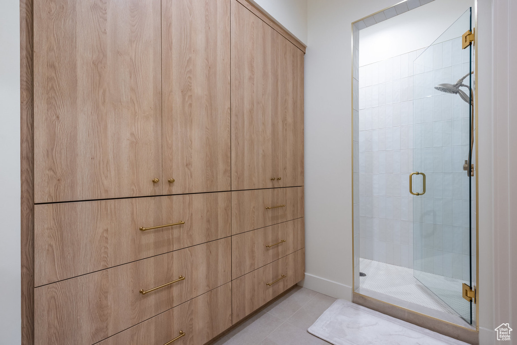 Bathroom with tile patterned flooring and a shower with door