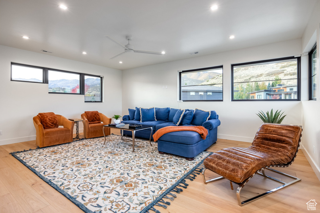 Living room featuring hardwood / wood-style flooring and ceiling fan