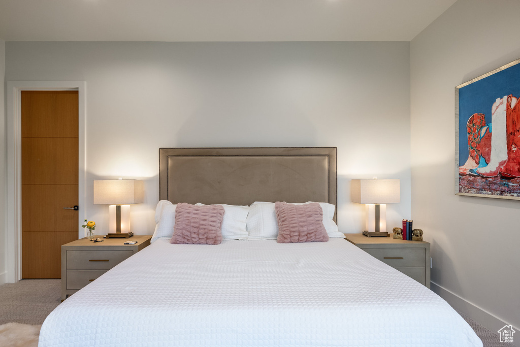 Bedroom featuring light colored carpet