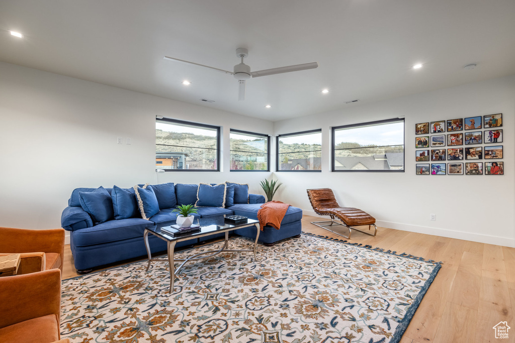 Living room featuring ceiling fan and light wood-type flooring