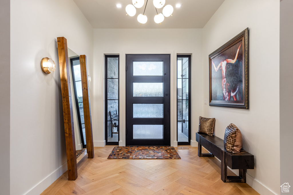 Foyer featuring a chandelier and light parquet floors