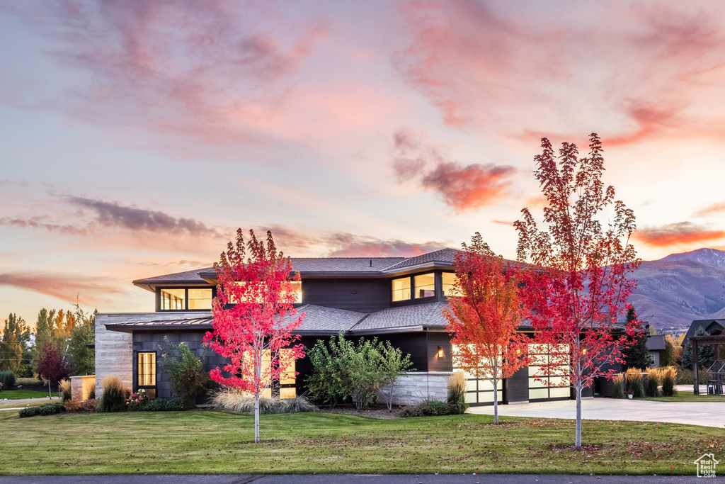 View of front facade featuring a lawn and a mountain view