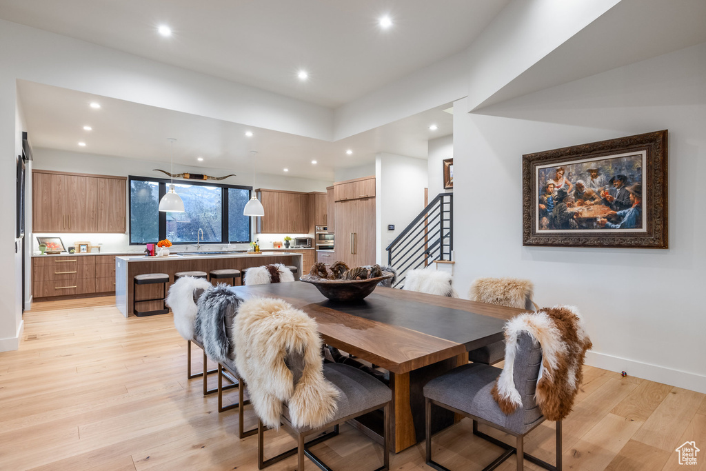 Dining space with light hardwood / wood-style floors