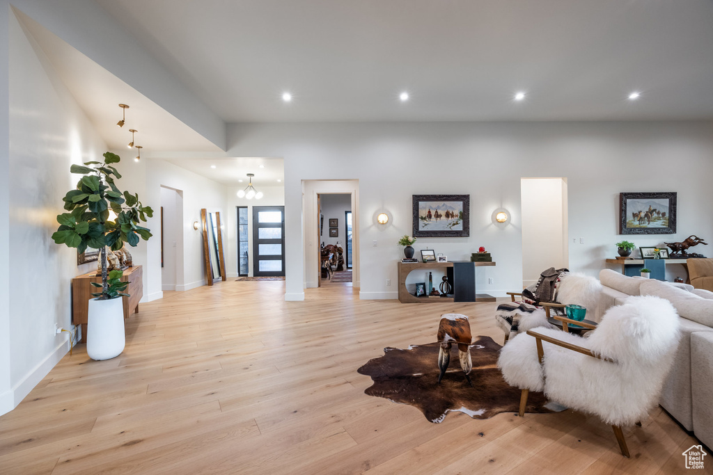 Living room with a chandelier and light hardwood / wood-style floors