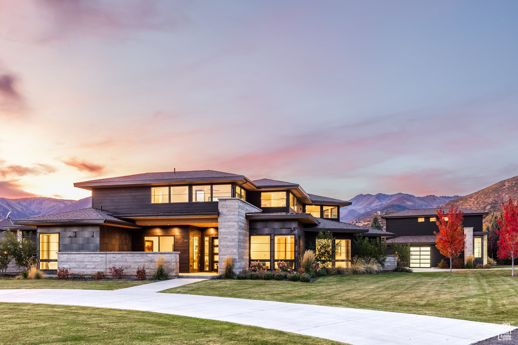 Prairie-style house with a mountain view and a yard