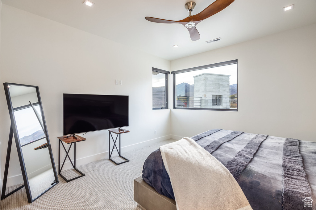 Bedroom with ceiling fan and carpet