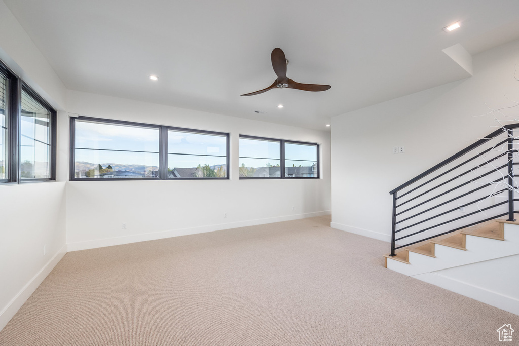 Spare room with light colored carpet and ceiling fan