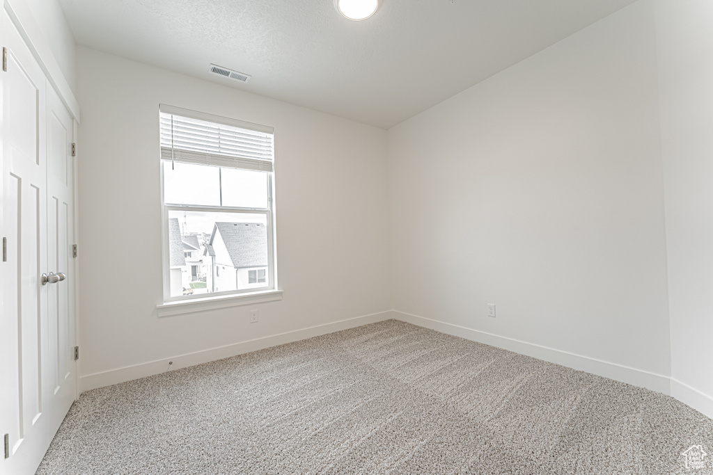Unfurnished bedroom featuring multiple windows, baseboards, and carpet