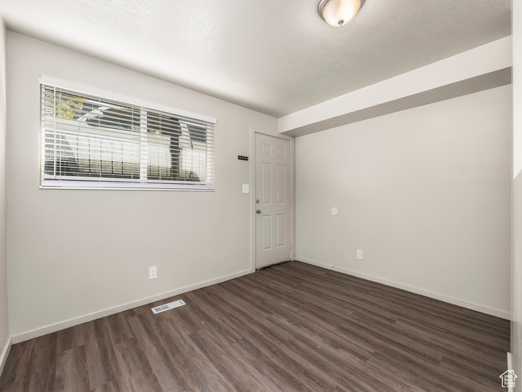 Unfurnished room with dark hardwood / wood-style flooring