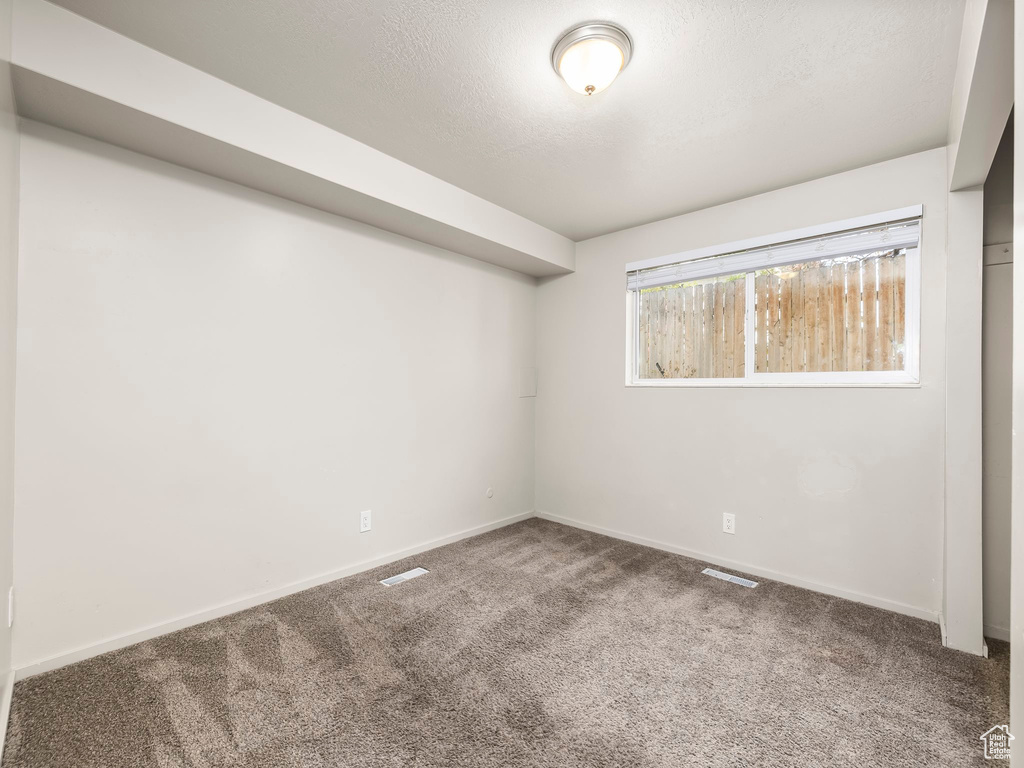 Spare room featuring carpet flooring