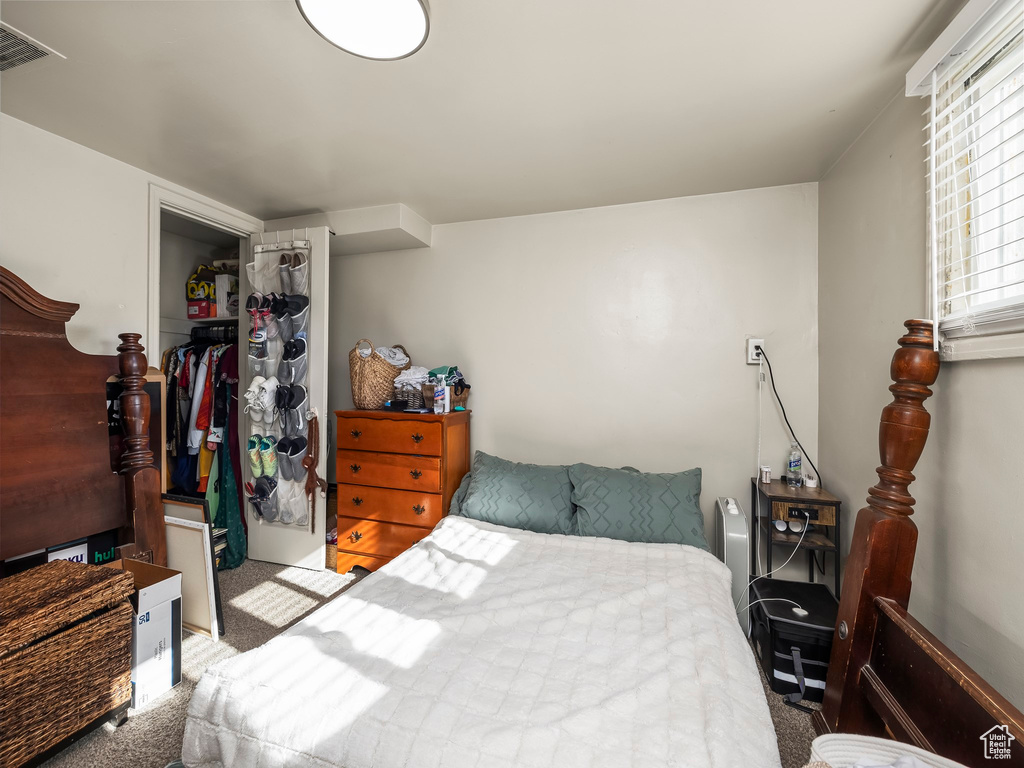 Carpeted bedroom featuring a closet