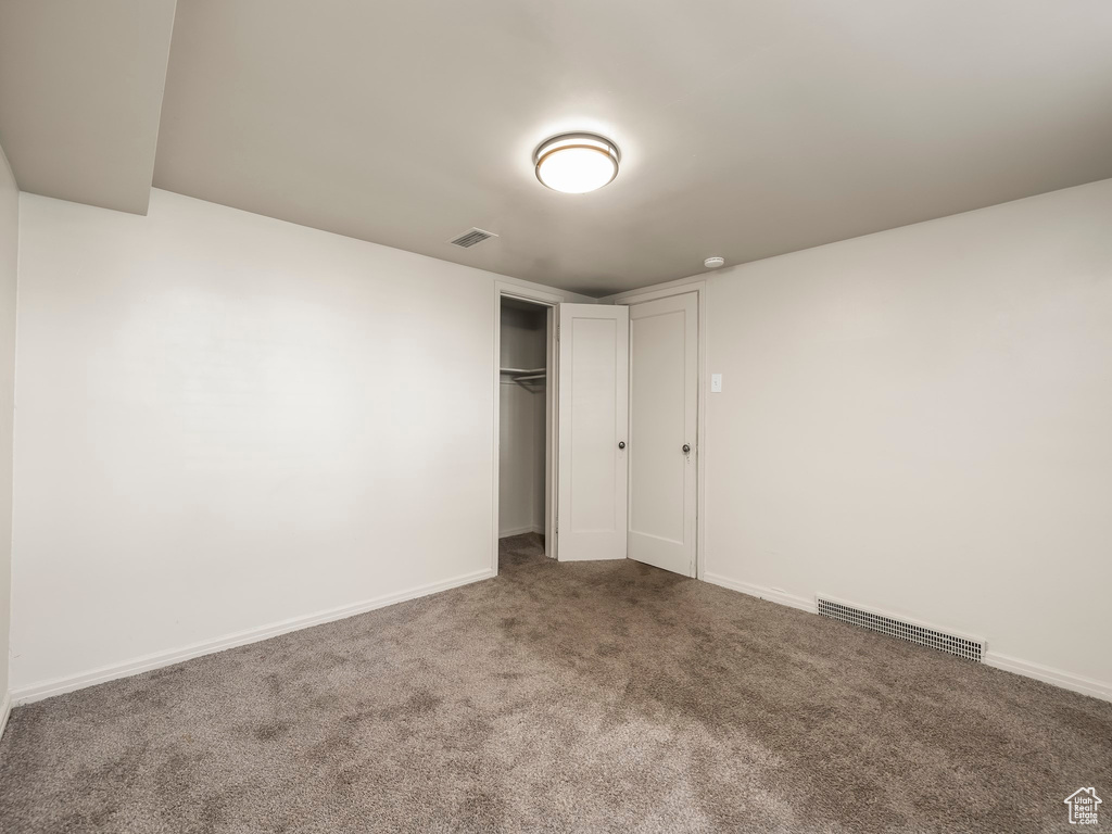 Unfurnished bedroom featuring carpet and a closet