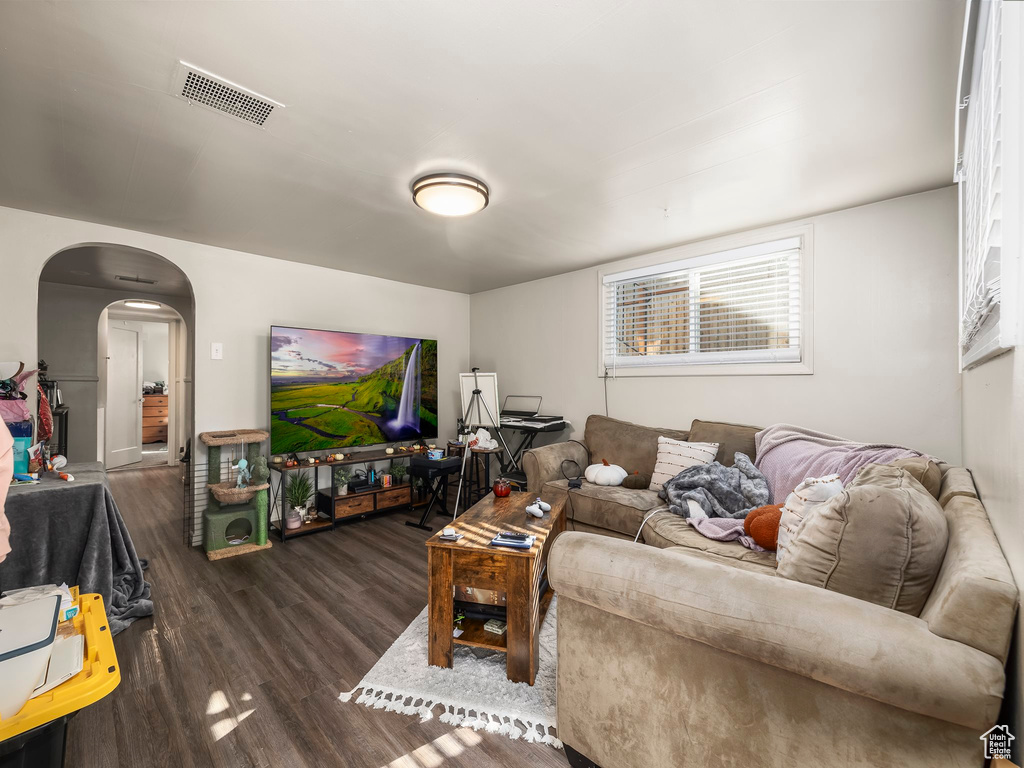 Living room with dark wood-type flooring