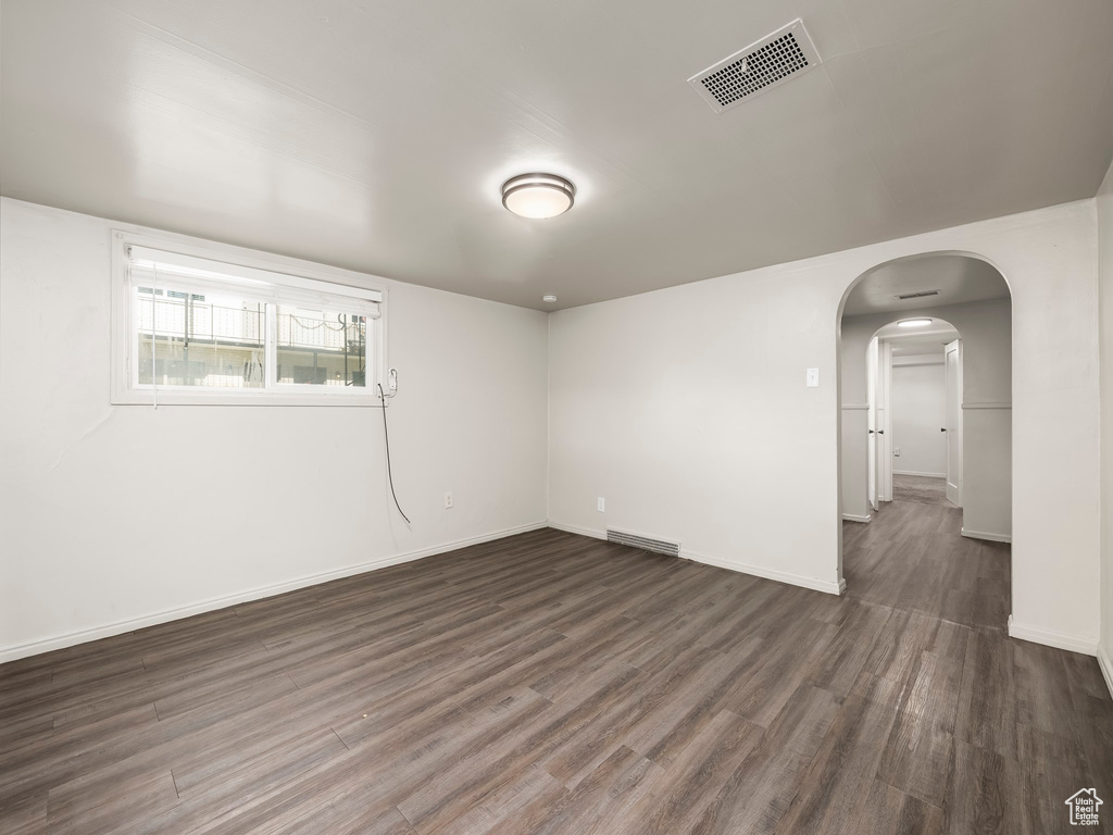 Spare room with dark wood-type flooring