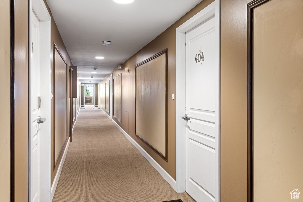 Hall featuring light colored carpet