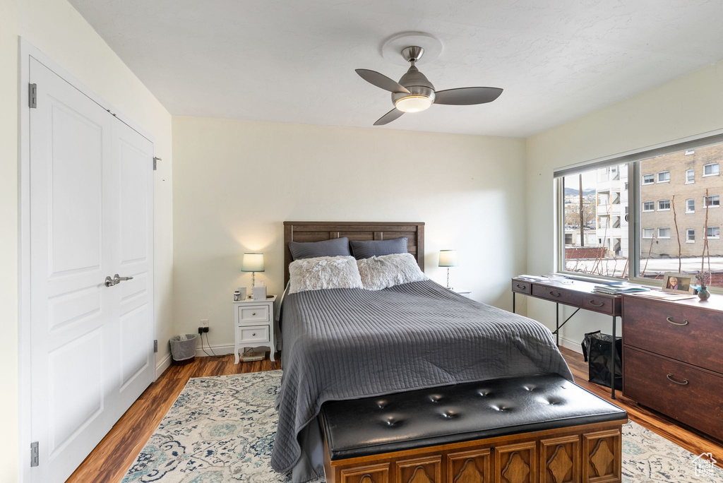 Bedroom with a closet, hardwood / wood-style floors, and ceiling fan