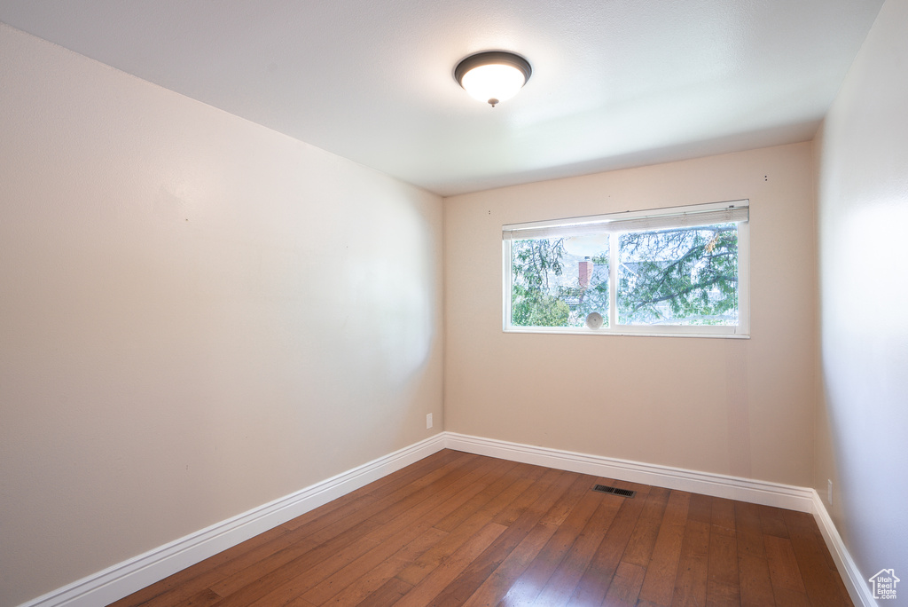 Unfurnished room with hardwood / wood-style flooring