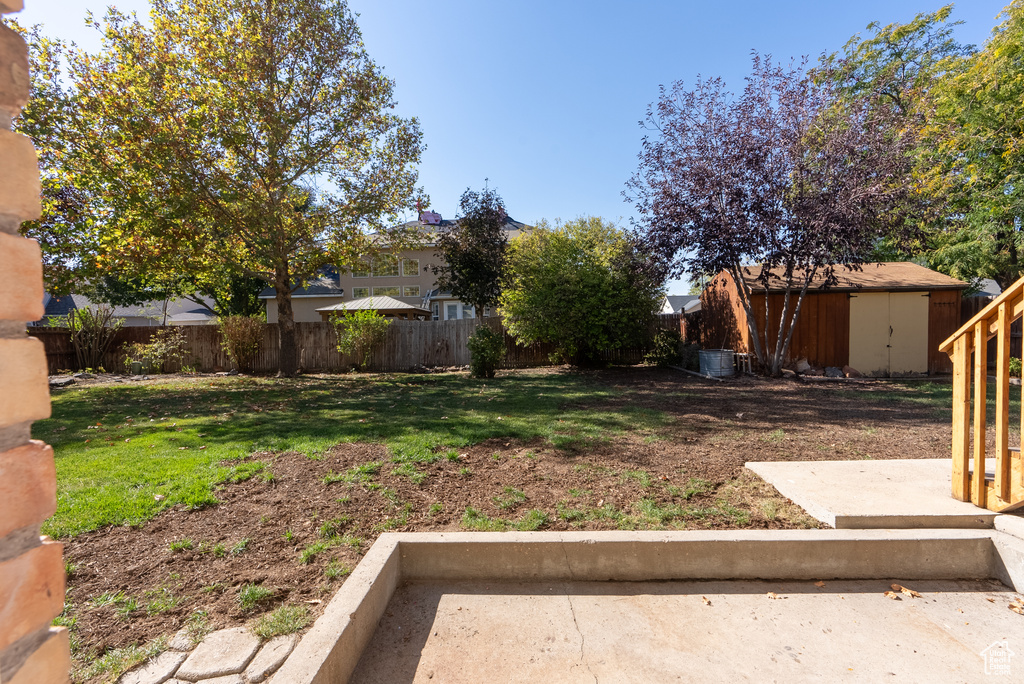 View of yard with a storage unit