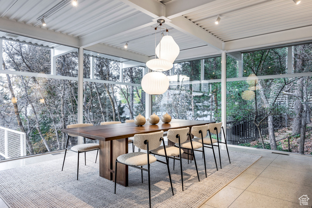 Sunroom / solarium with beamed ceiling and rail lighting