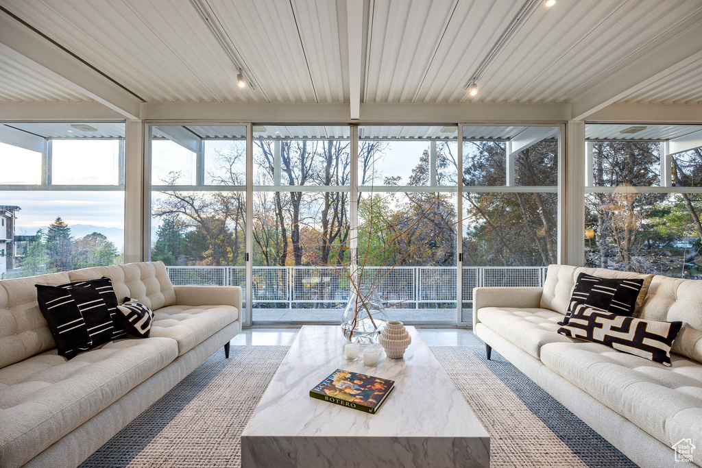 Sunroom / solarium featuring a healthy amount of sunlight and wood ceiling