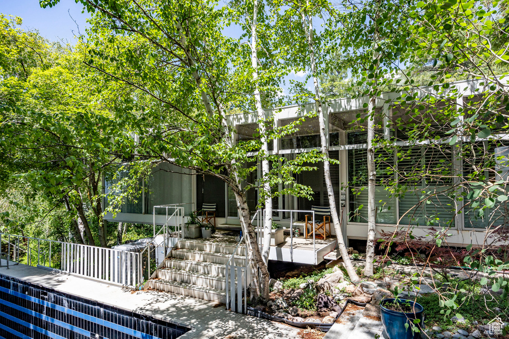 Exterior space featuring a sunroom