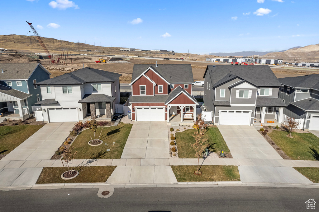 Townhome / multi-family property with a mountain view and a garage